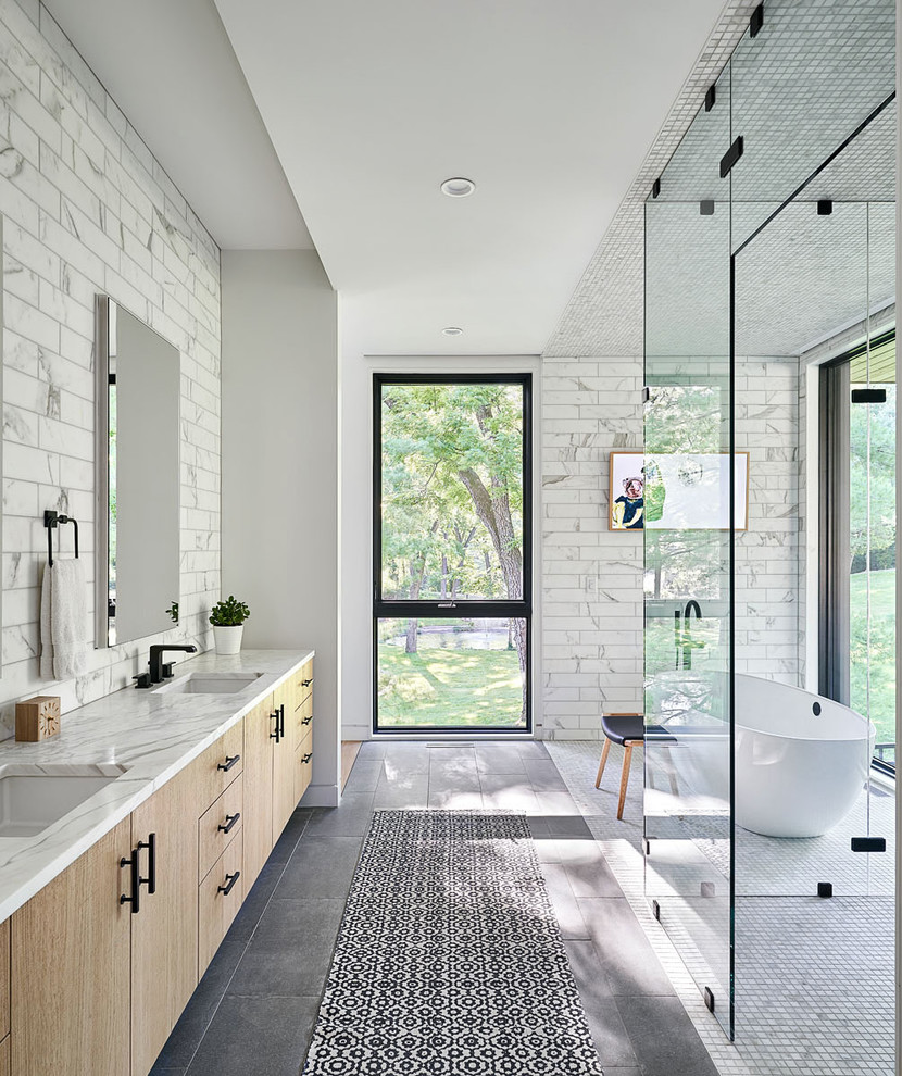 Trendy master gray tile and white tile gray floor bathroom photo in Kansas City with flat-panel cabinets, light wood cabinets, an undermount sink and white countertops