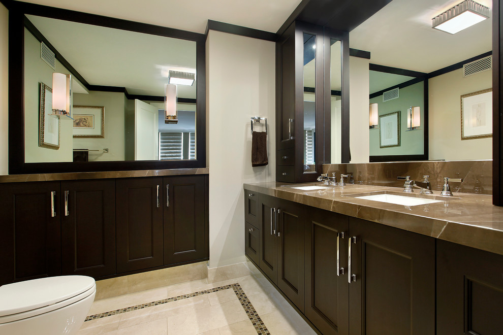 Traditional bathroom in Chicago with recessed-panel cabinets, brown cabinets, double sinks and a built in vanity unit.