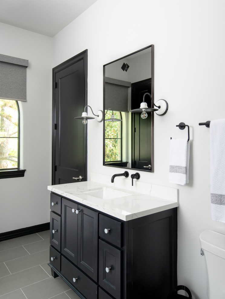 Design ideas for a small classic bathroom in Houston with shaker cabinets, black cabinets, white walls, porcelain flooring, grey floors, a freestanding vanity unit, engineered stone worktops, white worktops, a single sink and a submerged sink.