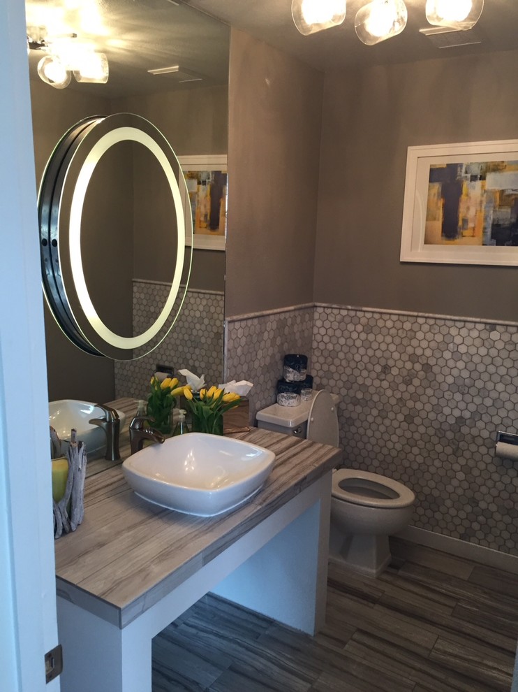 Bathroom - small modern gray tile and porcelain tile ceramic tile bathroom idea in Denver with a one-piece toilet, gray walls, a vessel sink and tile countertops