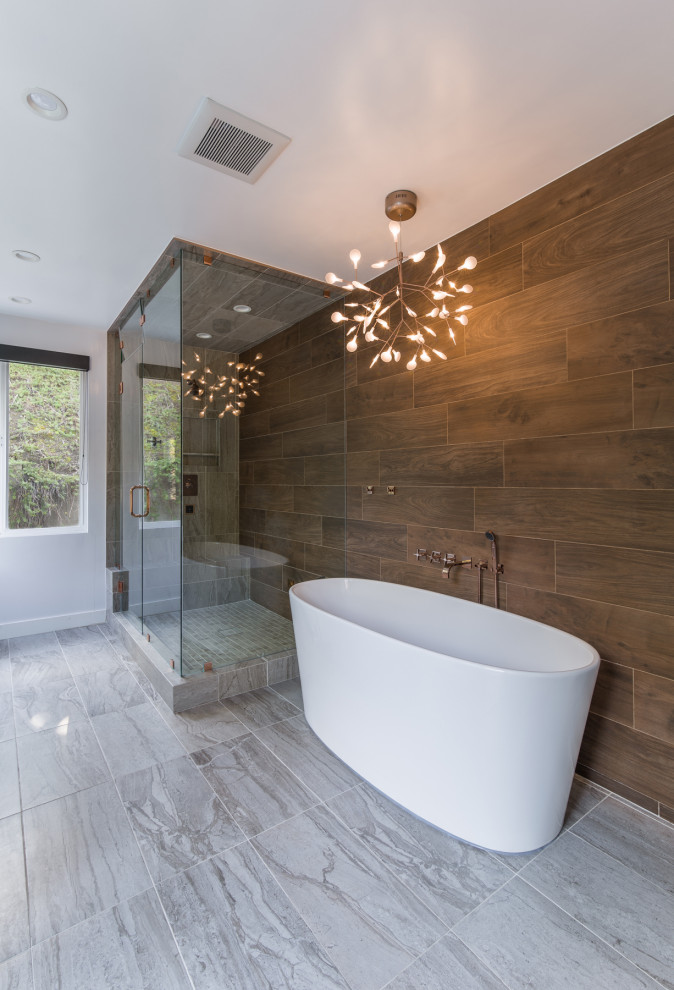 Design ideas for a large contemporary bathroom in Los Angeles with flat-panel cabinets, white cabinets, a freestanding bath, a one-piece toilet, brown tiles, porcelain tiles, white walls, porcelain flooring, a vessel sink, solid surface worktops, beige floors, a hinged door and white worktops.