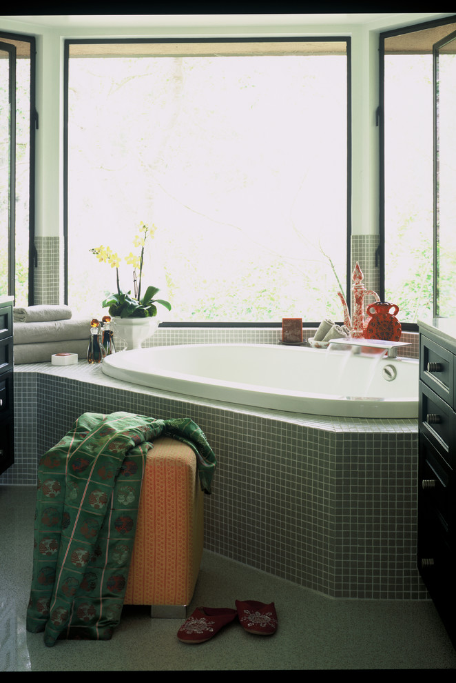 This is an example of a medium sized world-inspired bathroom in Los Angeles with a built-in bath, green tiles, mosaic tiles and green walls.