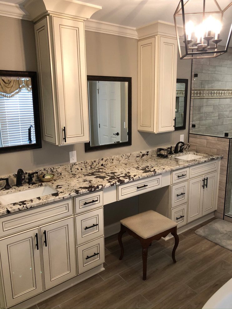 Inspiration for a mid-sized contemporary beige tile and subway tile ceramic tile and beige floor bathroom remodel in Atlanta with beige cabinets, a one-piece toilet, beige walls, a console sink, granite countertops, a hinged shower door and multicolored countertops