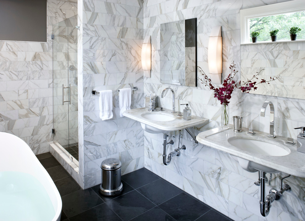 Mid-sized transitional master white tile and marble tile black floor bathroom photo in Boston with flat-panel cabinets, dark wood cabinets, gray walls, a wall-mount sink, marble countertops, a hinged shower door and white countertops