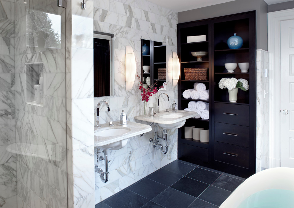 Bathroom - mid-sized transitional master white tile and marble tile black floor bathroom idea in Boston with flat-panel cabinets, dark wood cabinets, gray walls, a wall-mount sink, marble countertops, a hinged shower door and white countertops