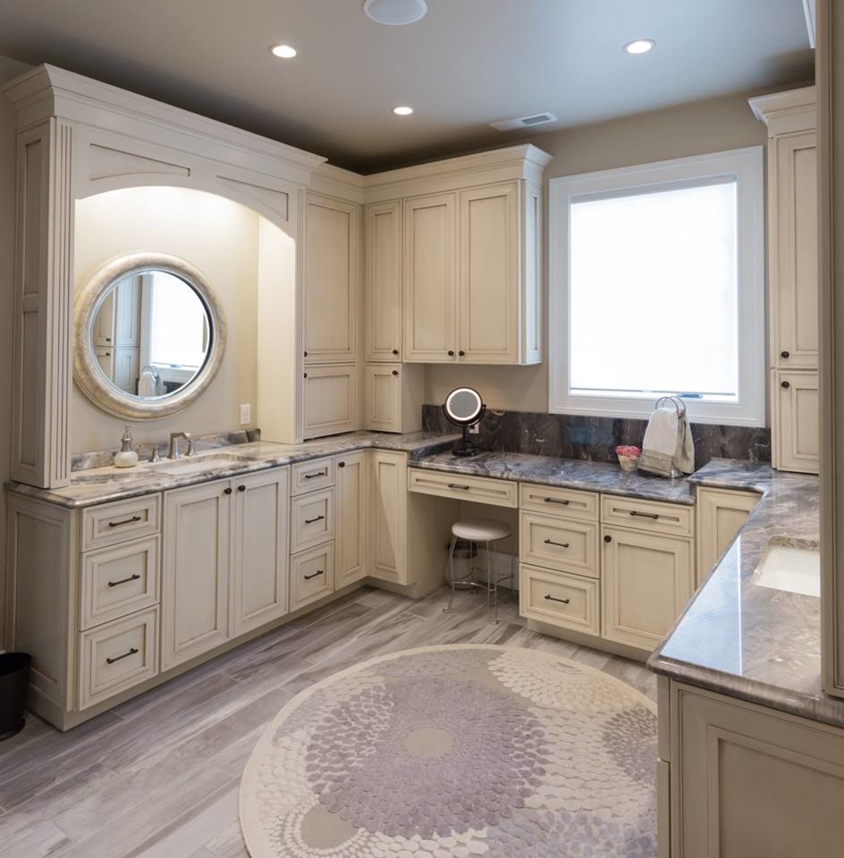 Mid-sized elegant master medium tone wood floor and brown floor bathroom photo in DC Metro with beaded inset cabinets, white cabinets, beige walls, an undermount sink, marble countertops and gray countertops