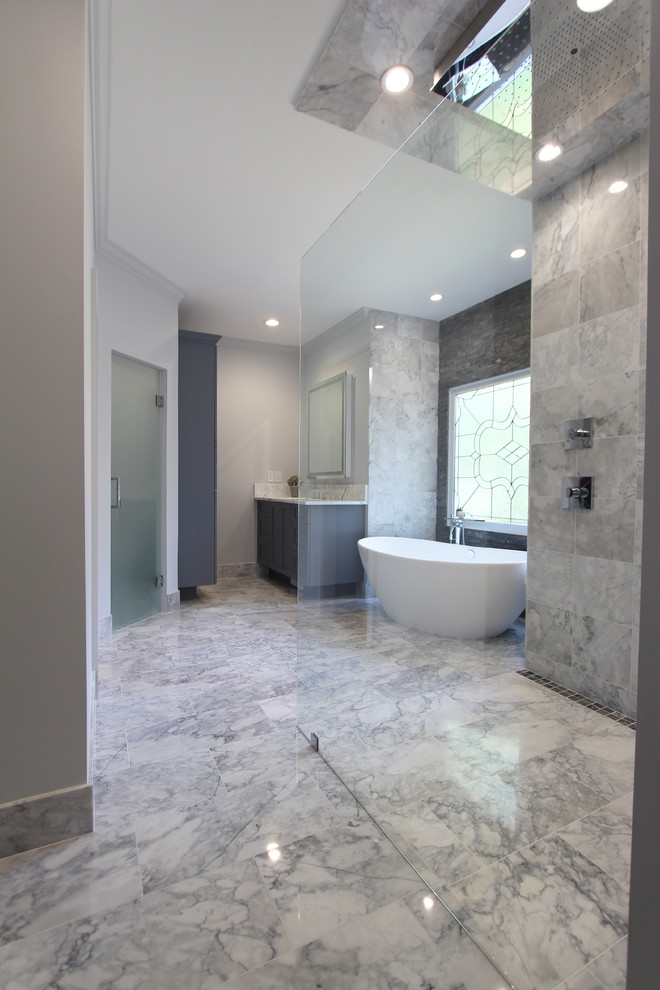 This is an example of a large contemporary ensuite bathroom in Atlanta with shaker cabinets, grey cabinets, a freestanding bath, a built-in shower, a two-piece toilet, black and white tiles, grey tiles, white tiles, stone tiles, grey walls, marble flooring, a submerged sink and marble worktops.