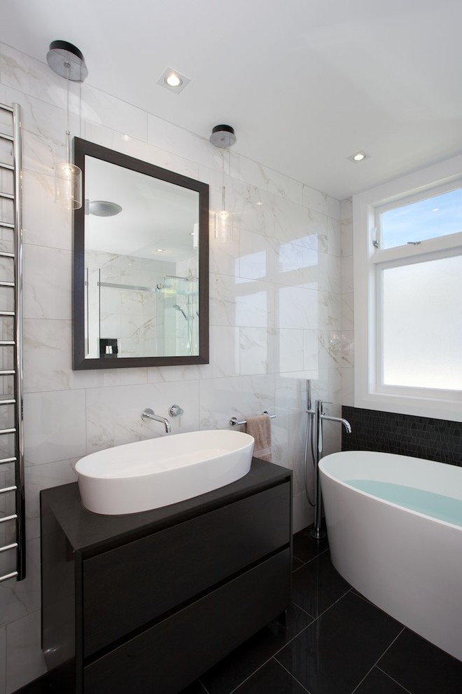 Example of a mid-sized minimalist kids' black tile and porcelain tile porcelain tile bathroom design in Auckland with a vessel sink, furniture-like cabinets, dark wood cabinets, quartz countertops, a one-piece toilet and white walls