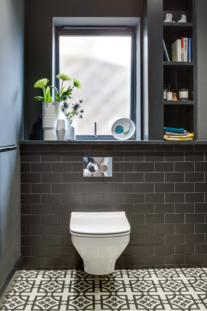 Medium sized contemporary family bathroom in Gloucestershire with black tiles, multi-coloured floors and a single sink.