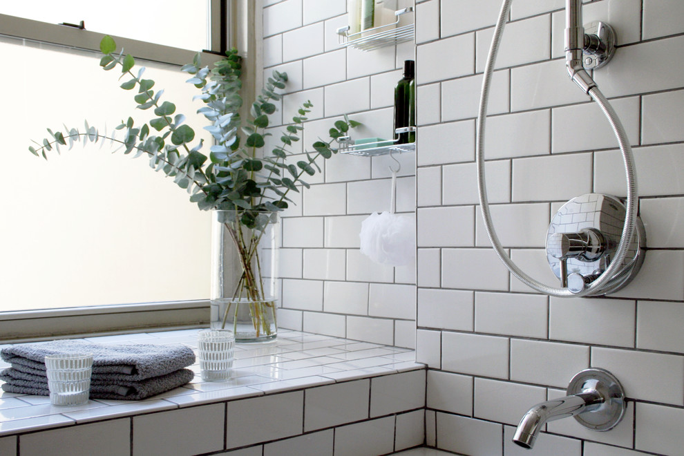 Example of a small danish gray tile and subway tile ceramic tile bathroom design in New York with a wall-mount sink, flat-panel cabinets, gray cabinets, marble countertops, a two-piece toilet and white walls