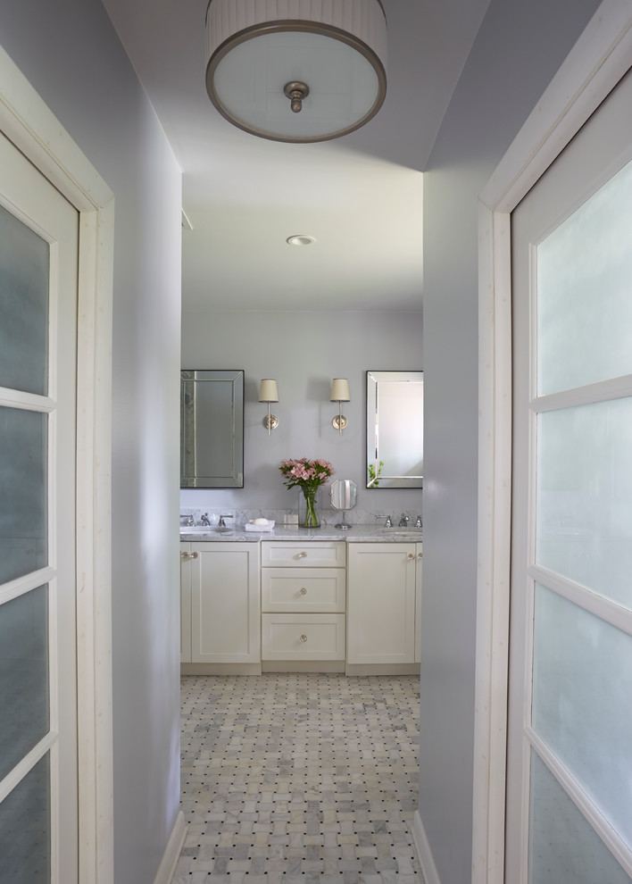 Example of a mid-sized transitional master gray tile and mosaic tile marble floor doorless shower design in Jacksonville with shaker cabinets, white cabinets, a one-piece toilet, gray walls, marble countertops and an undermount sink