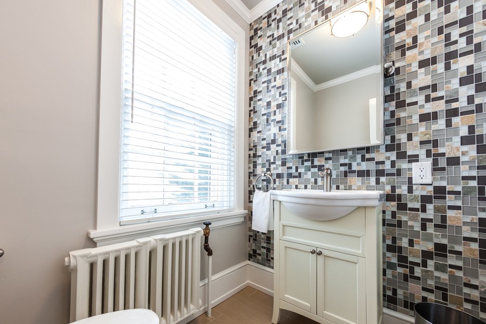 Small eclectic 3/4 multicolored tile and mosaic tile porcelain tile and beige floor bathroom photo in Other with flat-panel cabinets, white cabinets, a one-piece toilet, gray walls, an integrated sink and solid surface countertops