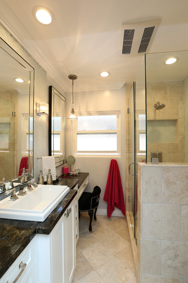 Mid-sized minimalist master beige tile and limestone tile limestone floor and beige floor double shower photo in Los Angeles with white cabinets, white walls, shaker cabinets, a two-piece toilet, a drop-in sink, granite countertops and a hinged shower door