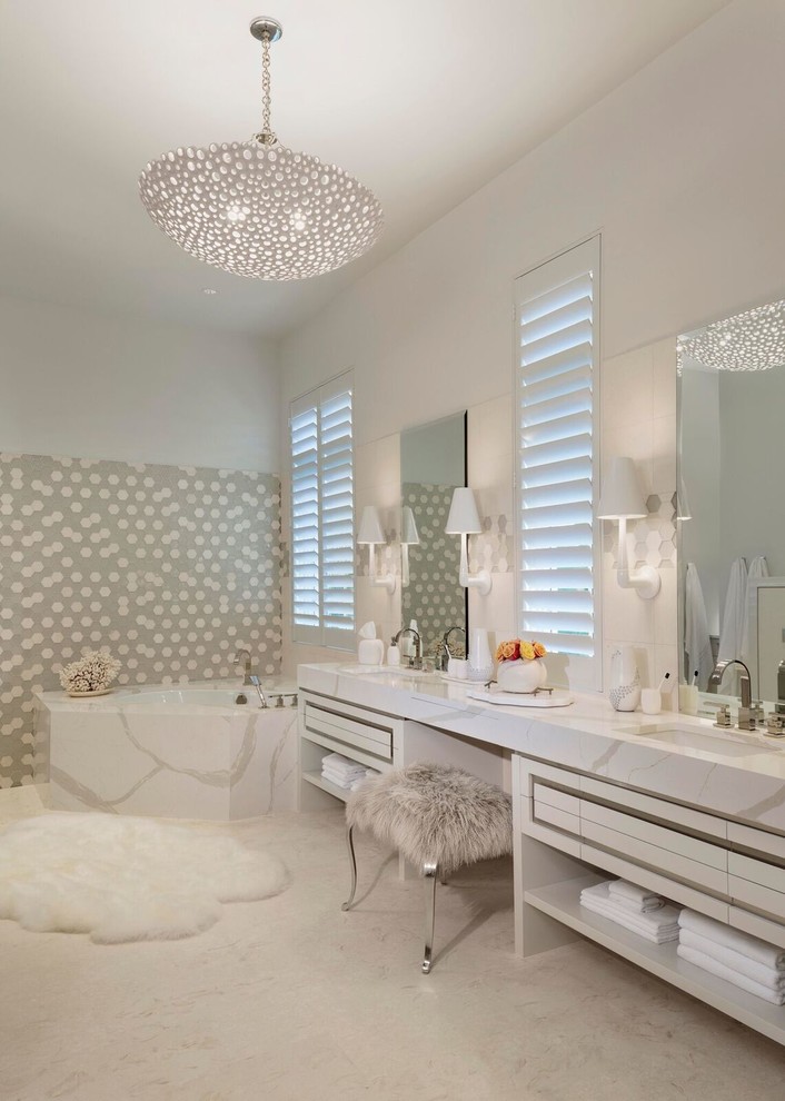 Inspiration for a large eclectic master beige tile limestone floor and beige floor corner bathtub remodel in Miami with raised-panel cabinets, white cabinets, white walls, an undermount sink and quartz countertops