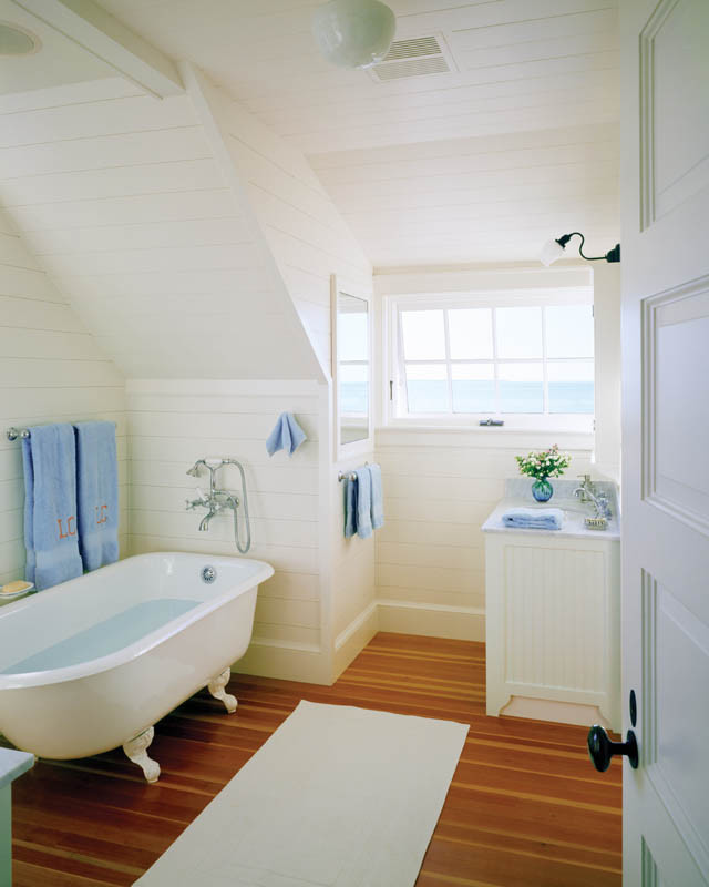 Ejemplo de cuarto de baño clásico pequeño con lavabo con pedestal, armarios tipo mueble, puertas de armario blancas, bañera exenta, paredes blancas y suelo de madera clara