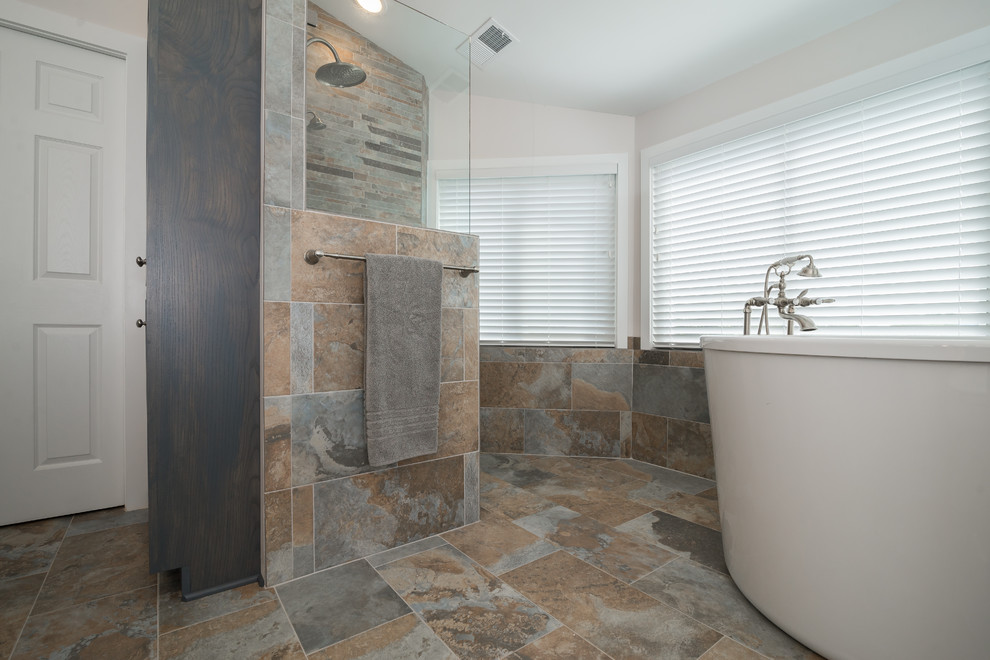 This is an example of a medium sized traditional ensuite bathroom in DC Metro with shaker cabinets, grey cabinets, a corner bath, a walk-in shower, a two-piece toilet, grey walls, travertine flooring, a submerged sink and granite worktops.
