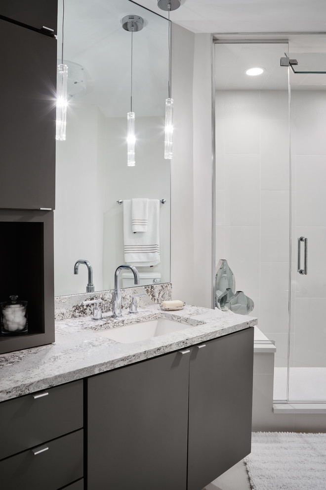 This is an example of a large contemporary ensuite bathroom in Chicago with white tiles, engineered stone worktops, an alcove shower, white walls, a built-in sink, flat-panel cabinets, grey cabinets, metro tiles and ceramic flooring.