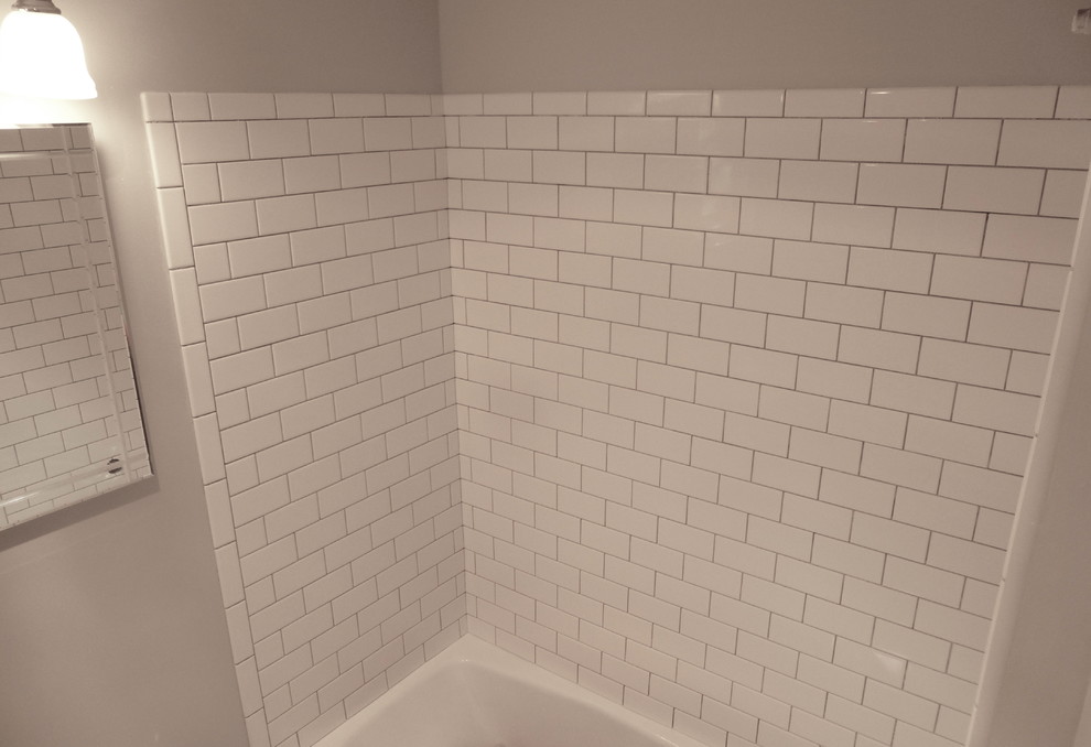 Example of a classic master white tile and porcelain tile bathroom design in Seattle with gray walls