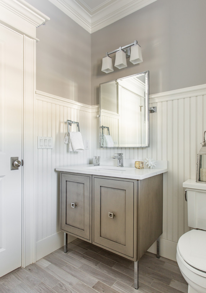 Inspiration for a small traditional bathroom in Boston with recessed-panel cabinets, grey cabinets, a two-piece toilet, white walls, ceramic flooring and engineered stone worktops.