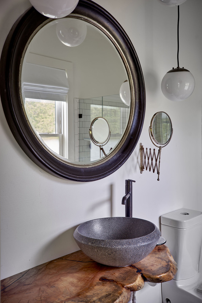 Inspiration for a mid-sized farmhouse bathroom remodel in Other with white walls, a vessel sink and wood countertops