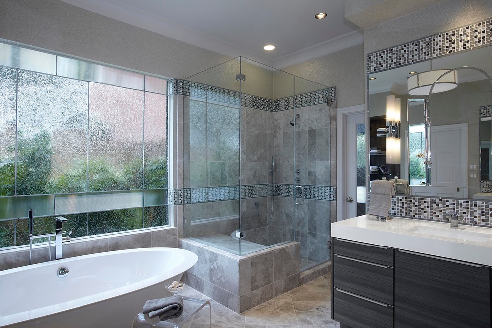Photo of a large contemporary bathroom in Houston with grey cabinets, a submerged sink, engineered stone worktops, a freestanding bath, a corner shower, multi-coloured tiles, mosaic tiles, beige walls, porcelain flooring and flat-panel cabinets.