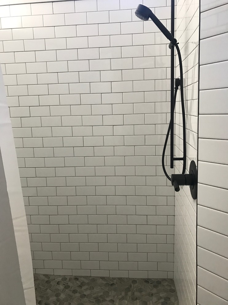 Doorless shower - rustic white tile and subway tile doorless shower idea in Burlington