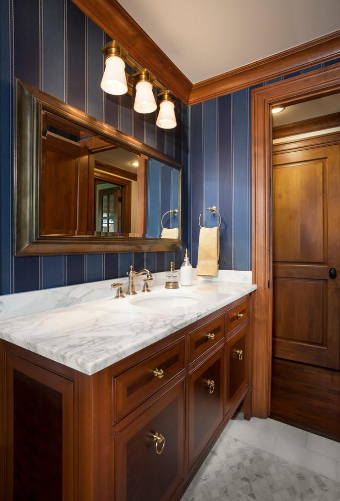 Alcove shower - mid-sized traditional 3/4 marble floor alcove shower idea in Salt Lake City with an undermount sink, furniture-like cabinets, medium tone wood cabinets, marble countertops, a one-piece toilet and blue walls