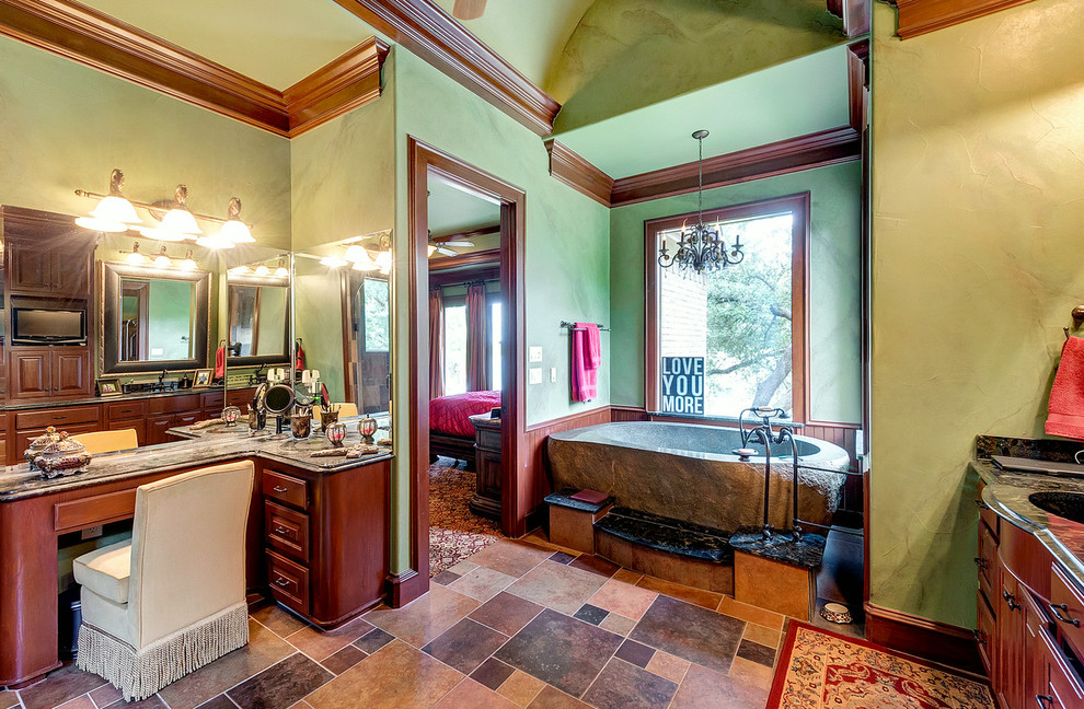 This is an example of a large mediterranean master bathroom in Dallas with raised-panel cabinets, medium wood cabinets, a freestanding tub, an alcove shower, multi-coloured tile, cement tile, green walls, ceramic floors, an undermount sink, granite benchtops, multi-coloured floor, a hinged shower door and green benchtops.