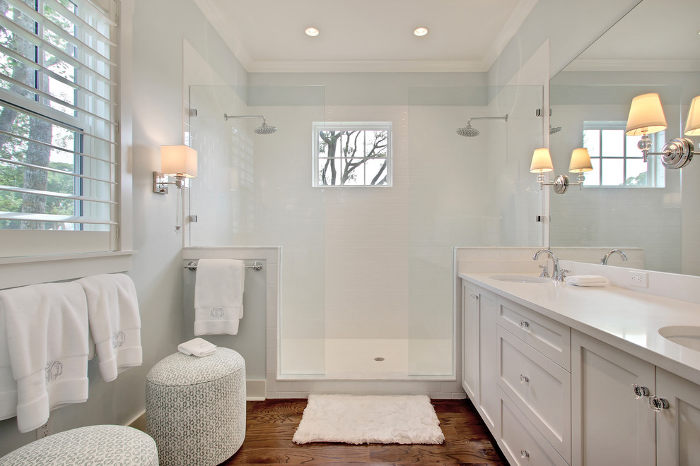 Inspiration for a large transitional master white tile and porcelain tile medium tone wood floor and brown floor bathroom remodel in Jacksonville with an undermount sink, shaker cabinets, white cabinets, marble countertops and blue walls