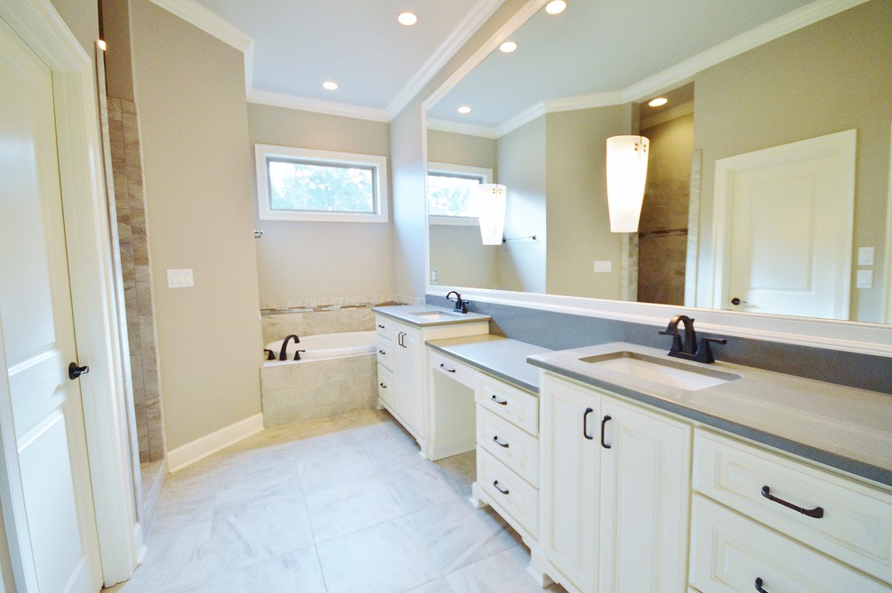 Mid-sized elegant master beige tile and ceramic tile ceramic tile bathroom photo in Little Rock with an undermount sink, raised-panel cabinets, white cabinets, quartz countertops and gray walls