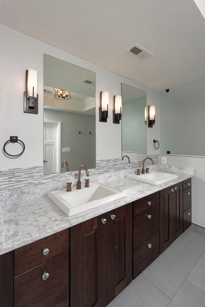 Large arts and crafts master gray tile and ceramic tile ceramic tile and gray floor bathroom photo in DC Metro with a drop-in sink, raised-panel cabinets, dark wood cabinets, quartz countertops, a two-piece toilet and gray walls