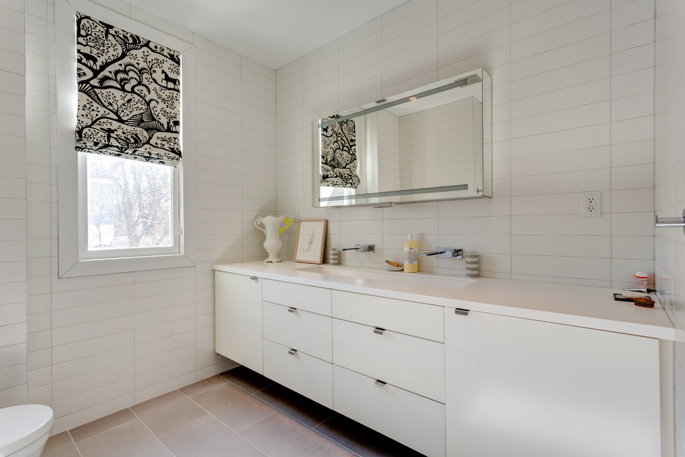 Bathroom - mid-sized modern master white tile and subway tile travertine floor and beige floor bathroom idea in New York with flat-panel cabinets, white cabinets, white walls, a trough sink, wood countertops and a two-piece toilet