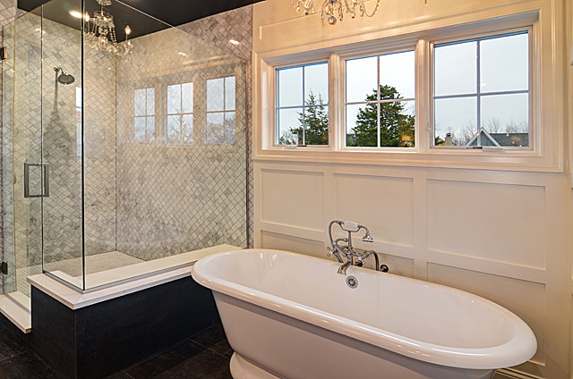 На фото: главная ванная комната среднего размера в классическом стиле с отдельно стоящей ванной, серой плиткой, каменной плиткой, белыми стенами, полом из керамогранита и столешницей из искусственного кварца с