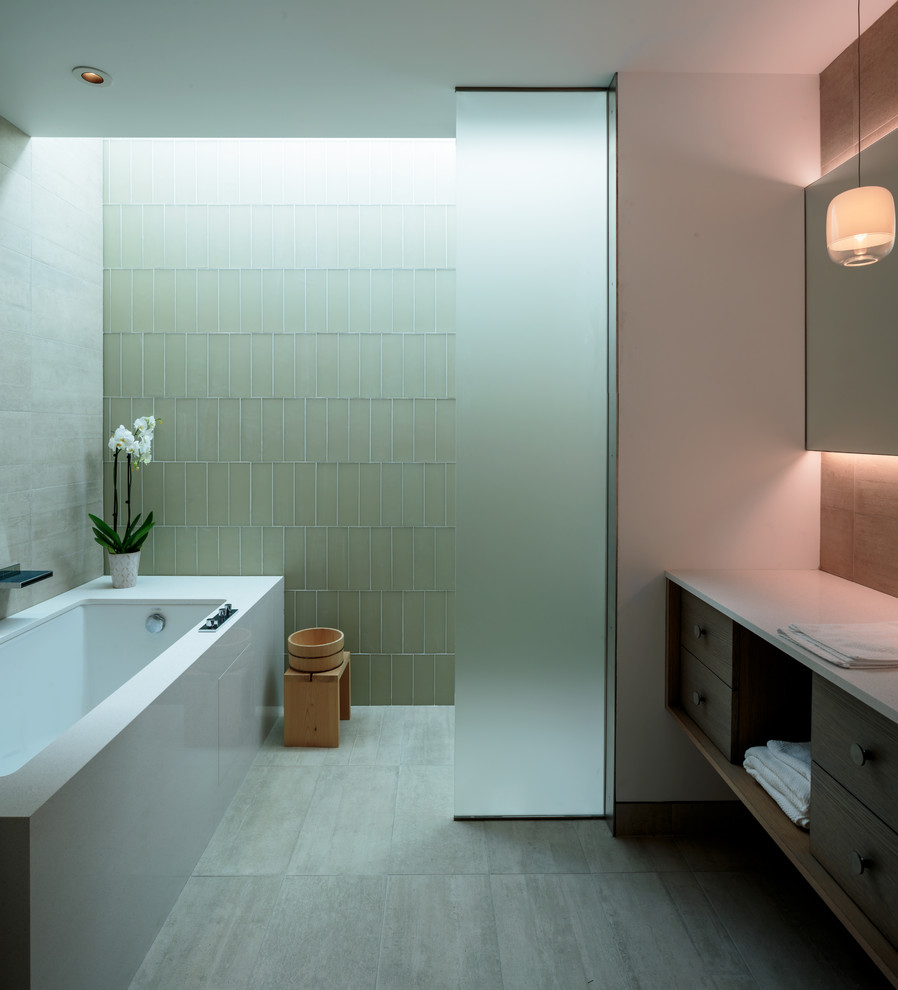 На фото: главная ванная комната в стиле ретро с плоскими фасадами, серыми фасадами, японской ванной, душем в нише, зеленой плиткой, стеклянной плиткой, белыми стенами, серым полом, открытым душем и белой столешницей с