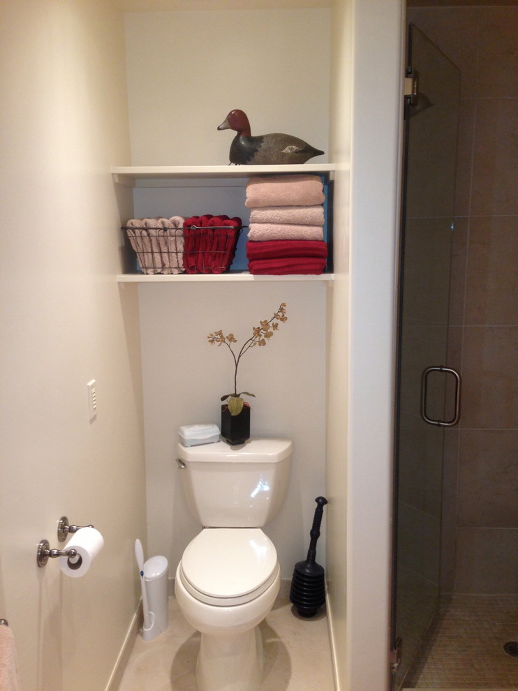 Example of a small classic 3/4 alcove shower design in Other with open cabinets, white cabinets, a one-piece toilet and white walls