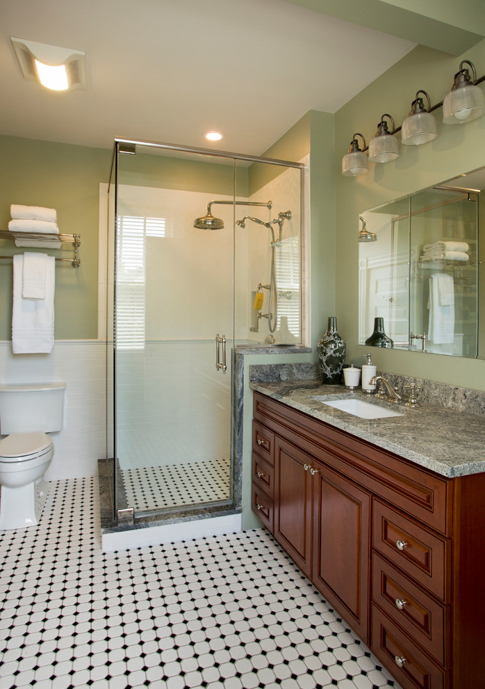 Mid-sized mid-century modern master white tile ceramic tile corner shower photo in Boston with raised-panel cabinets, medium tone wood cabinets, granite countertops, a two-piece toilet and green walls