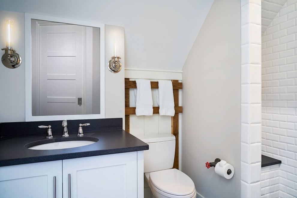 Cette photo montre une petite salle de bain chic avec des portes de placard blanches, une douche ouverte, WC à poser, un carrelage blanc, un mur blanc, un lavabo encastré et un plan de toilette en granite.
