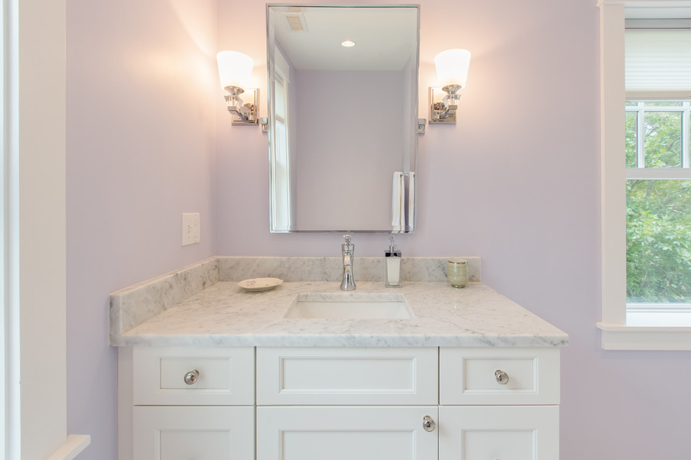 Photo of a small classic family bathroom in Boston with flat-panel cabinets, white cabinets, an alcove bath, a shower/bath combination, white tiles, metro tiles, purple walls, marble flooring, a submerged sink, marble worktops, white floors and a shower curtain.