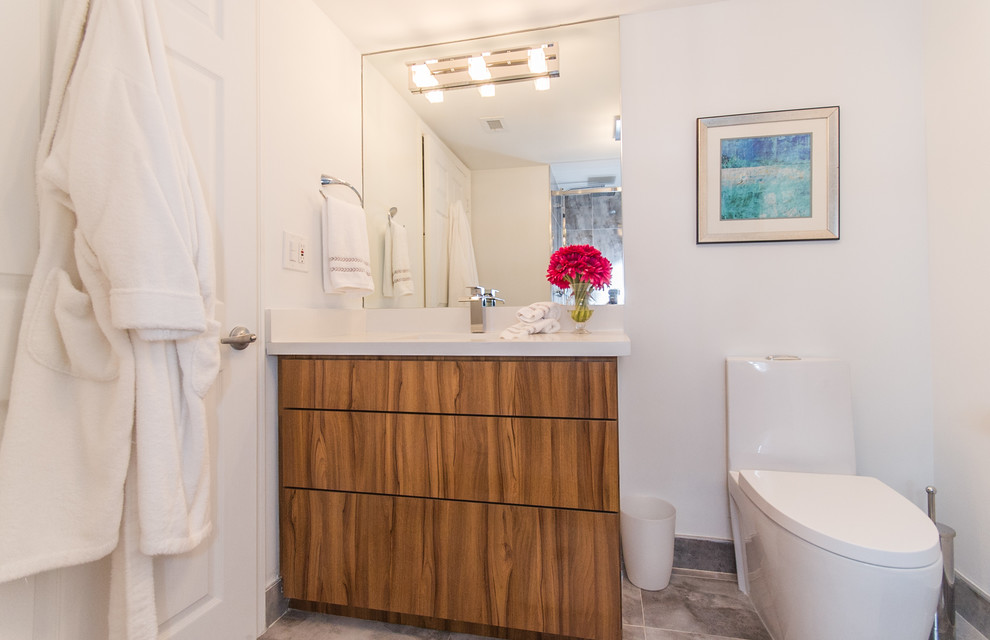 Idéer för att renovera ett litet funkis en-suite badrum, med ett undermonterad handfat, släta luckor, skåp i mellenmörkt trä, bänkskiva i kvarts, en öppen dusch, en toalettstol med separat cisternkåpa, grå kakel, porslinskakel, vita väggar, klinkergolv i porslin och grått golv