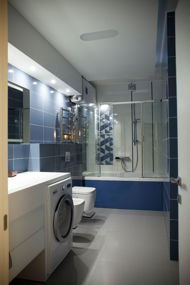 Ejemplo de cuarto de baño principal retro pequeño con lavabo integrado, encimera de cuarcita, bañera encastrada, combinación de ducha y bañera, sanitario de pared, baldosas y/o azulejos azules, baldosas y/o azulejos de cerámica, paredes azules y suelo de baldosas de cerámica