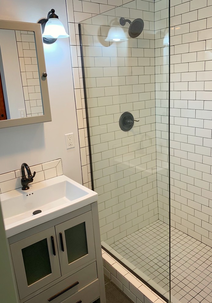 Small transitional 3/4 white tile and subway tile slate floor bathroom photo in San Francisco with flat-panel cabinets, white cabinets, an integrated sink, solid surface countertops and white countertops
