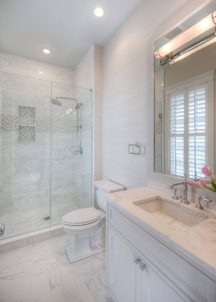 Photo of a medium sized classic shower room bathroom in Philadelphia with shaker cabinets, white cabinets, an alcove shower, beige walls, marble flooring, a submerged sink, engineered stone worktops, white floors and a hinged door.