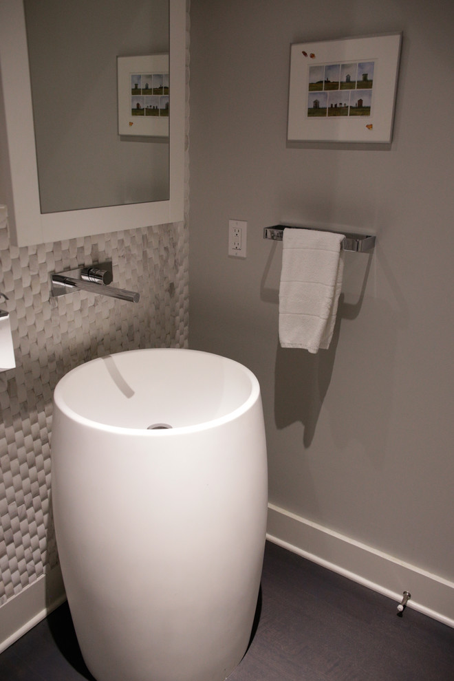 Example of a mid-sized trendy 3/4 gray tile and stone tile dark wood floor bathroom design in Vancouver with a pedestal sink, glass-front cabinets, white cabinets, quartz countertops, a one-piece toilet and gray walls