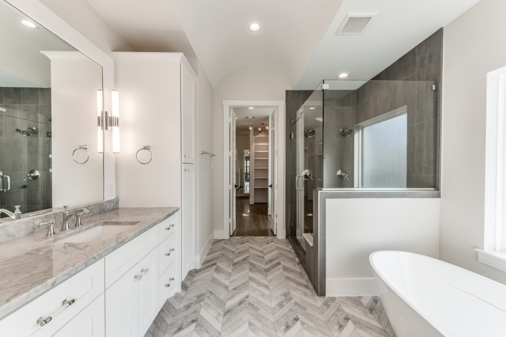 Example of a large transitional master black tile and porcelain tile porcelain tile and gray floor bathroom design in Houston with shaker cabinets, gray cabinets, white walls, an undermount sink, marble countertops, a hinged shower door and white countertops