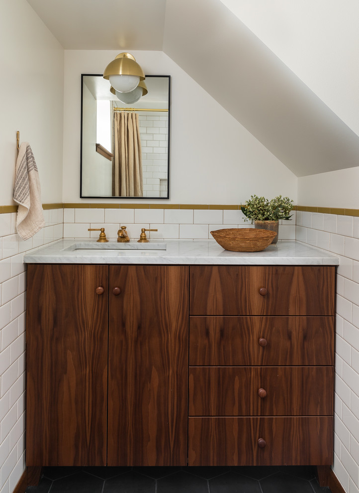 Retro bathroom in Seattle with flat-panel cabinets, medium wood cabinets, white tiles, metro tiles, white walls, a submerged sink, grey floors and white worktops.