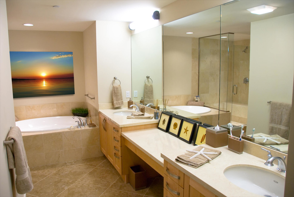 На фото: главная ванная комната в морском стиле с светлыми деревянными фасадами, угловой ванной, коричневой плиткой, керамической плиткой, белыми стенами, полом из керамогранита, накладной раковиной и мраморной столешницей с