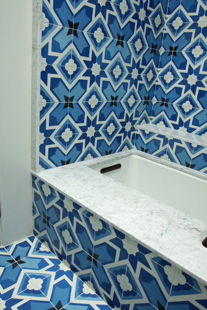 Inspiration for a mid-sized contemporary master blue tile and cement tile concrete floor tub/shower combo remodel in Los Angeles with an undermount sink, flat-panel cabinets, dark wood cabinets, marble countertops, an undermount tub, a one-piece toilet and white walls