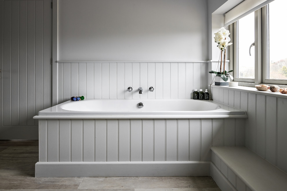 Design ideas for a small coastal family bathroom in Hampshire with flat-panel cabinets, grey cabinets, a built-in bath and grey walls.