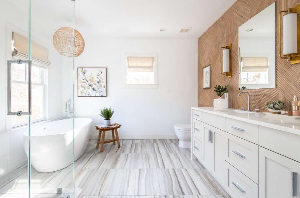 Inspiration for a classic ensuite bathroom in DC Metro with shaker cabinets, beige cabinets, a freestanding bath, a submerged sink, multi-coloured floors, a hinged door, white worktops, double sinks and a built in vanity unit.