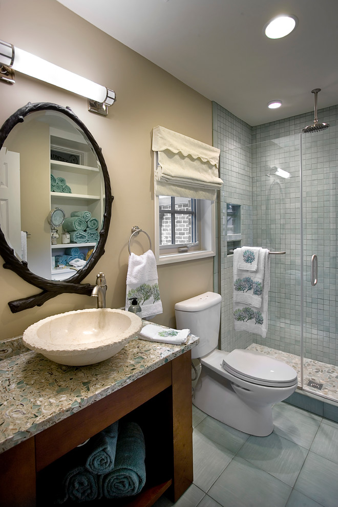 Inspiration for a mid-sized timeless blue tile and ceramic tile ceramic tile and gray floor alcove shower remodel in Other with open cabinets, dark wood cabinets, a two-piece toilet, brown walls, a vessel sink, glass countertops and a hinged shower door